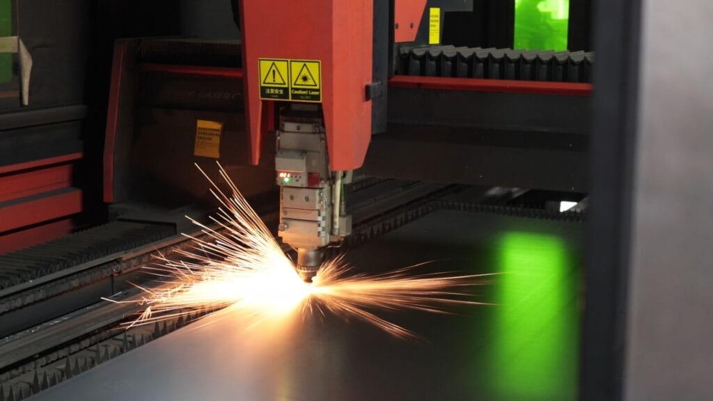 fiber laser cutting steel sheet intense sparks closeup